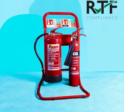 Fire Extinguisher Servicing and Maintenance, pair of red fire extinguisher on a red metal stand commissioned and fully serviced with a blue background
