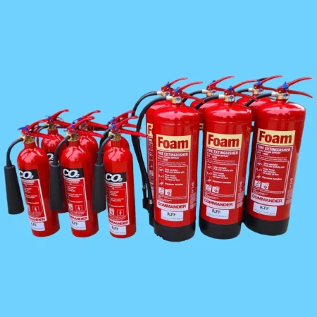 A group of red fire extinguishers with RTF Compliance labels displayed. Serviced and maintained by RTF Compliance.