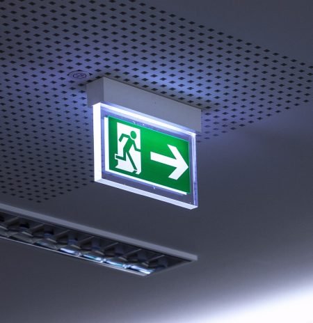 Emergency light testing. green sign fire exit light with arrow pointing to the right